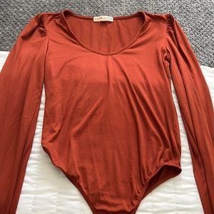 Large burnt orange body suit, condition: good